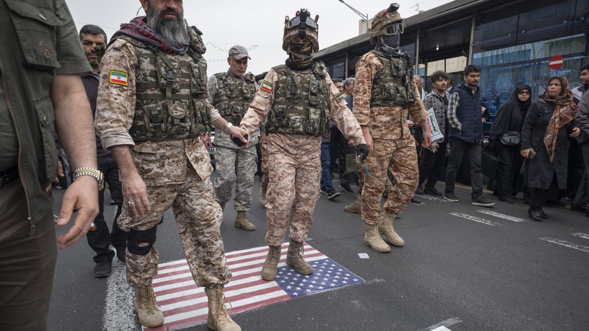 The special forces of the Islamic Revolutionary Guard (IRGC) walk along the United States flag during a rally commemorating International QDS Day, also known as Jerusalem Day, in Tehran, Iran, on March 28, 2025.