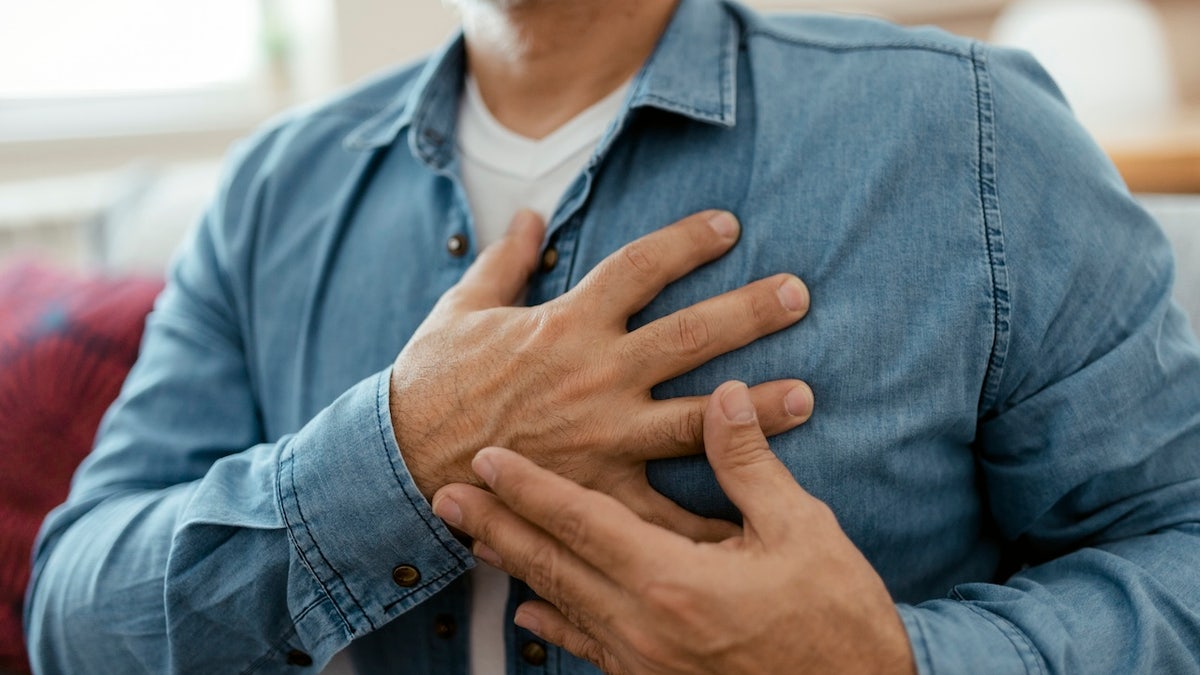 Man holding his chest