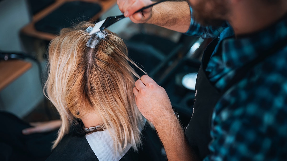 Woman who stained her hair in a living room