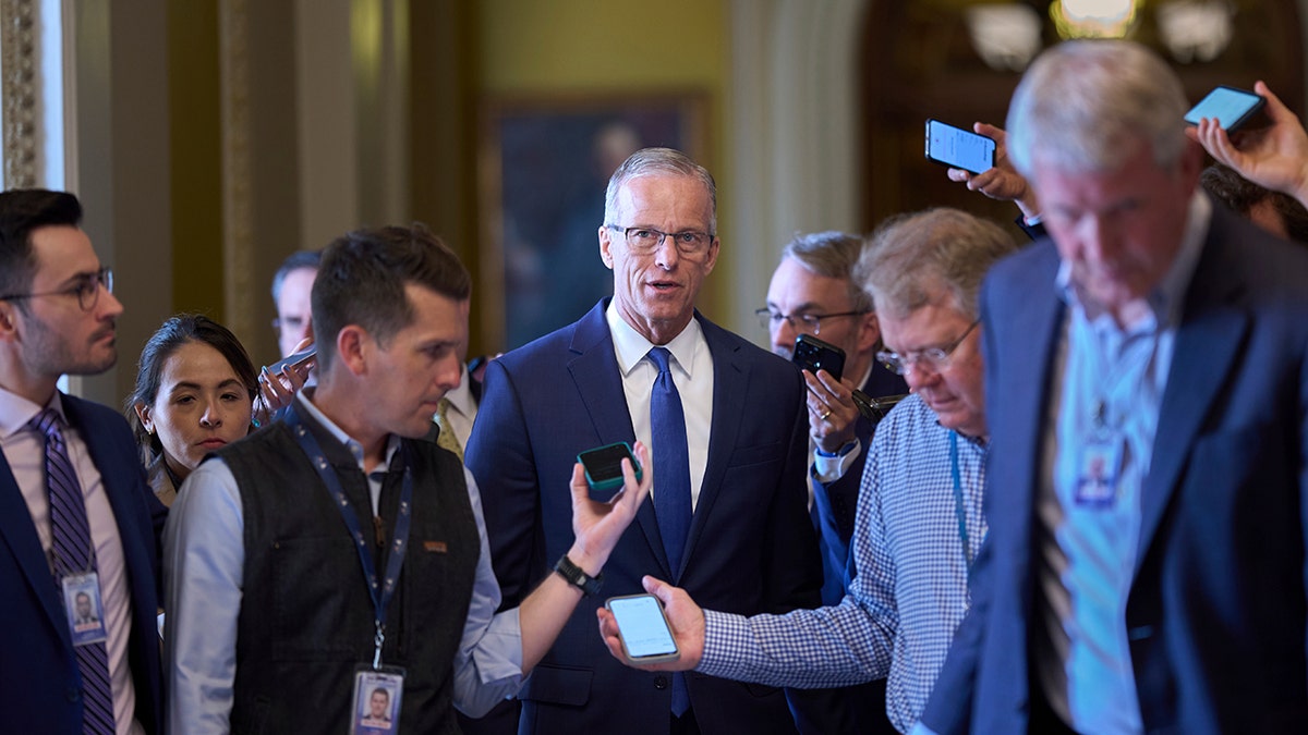 Thune walks with journalists